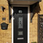 A black door installed at the front of a house
