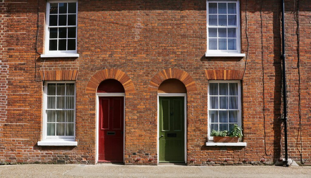 image of two houses with one red front door and one green front door